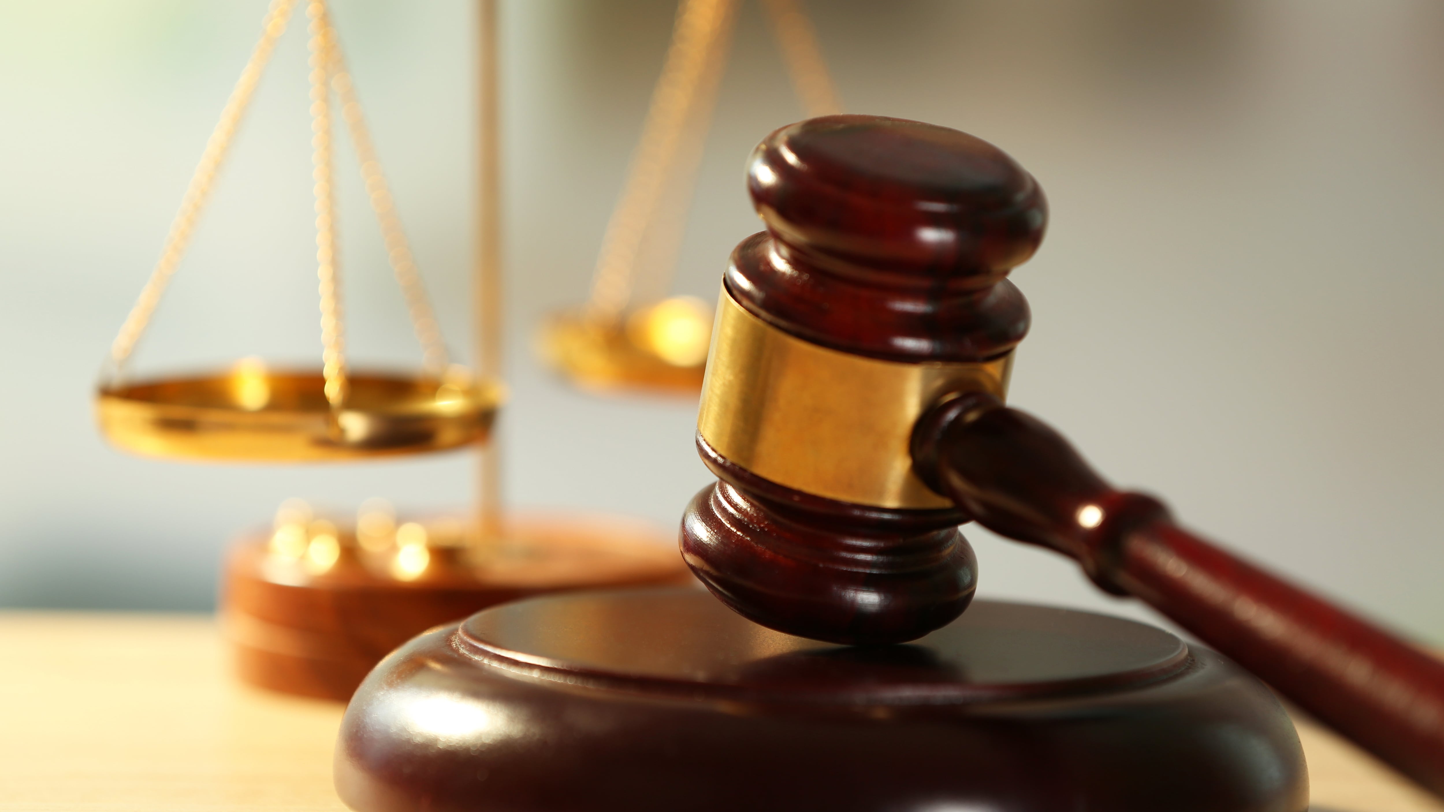 Wooden judges gavel on wooden table, close up