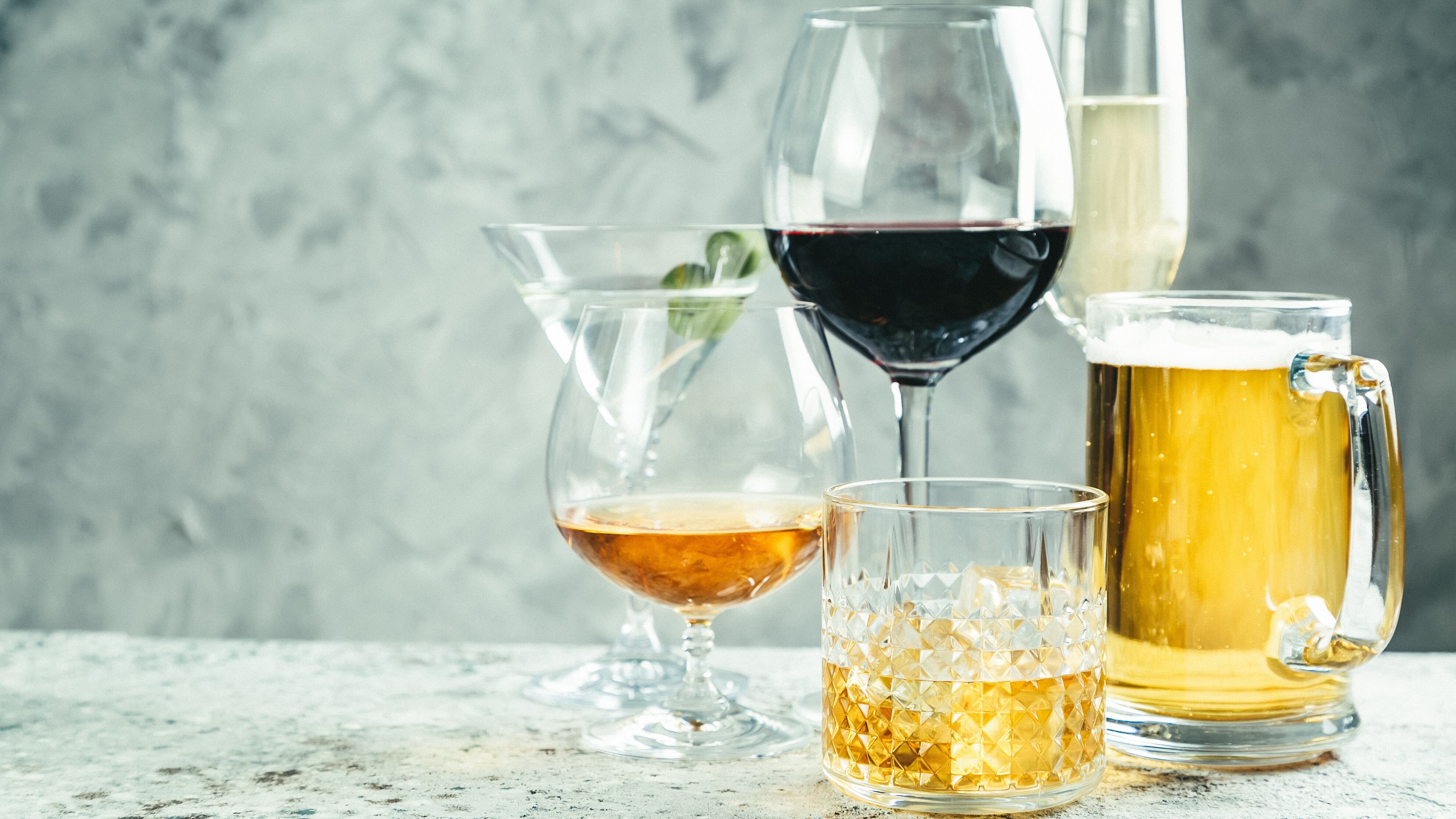 Selection of alcoholic drinks - beer, wine, martini, champagne, cognac, whiskey, rustic background